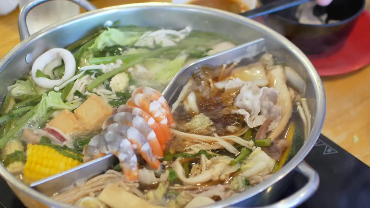 4k video POV to the hotpot shabu shabu in chinese style with vetgetable in pot