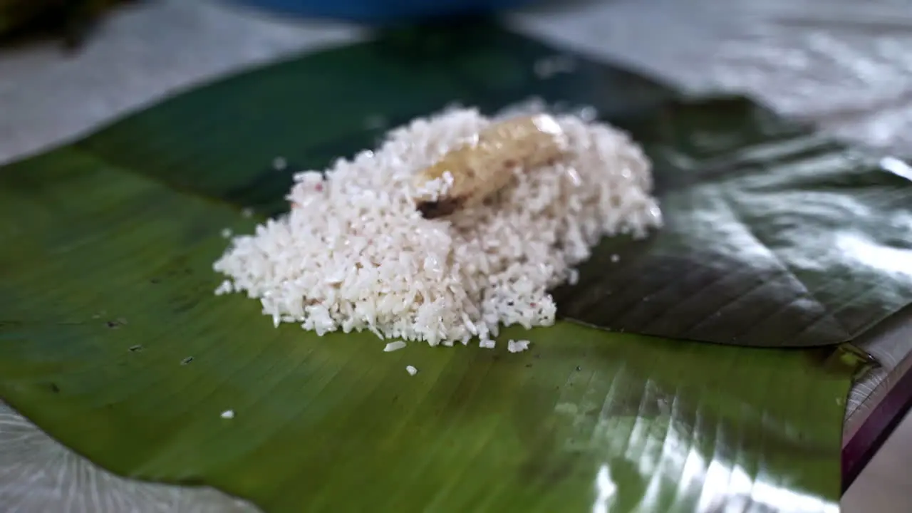 Preparation of rice and banana animal food in palm leaf for elephants