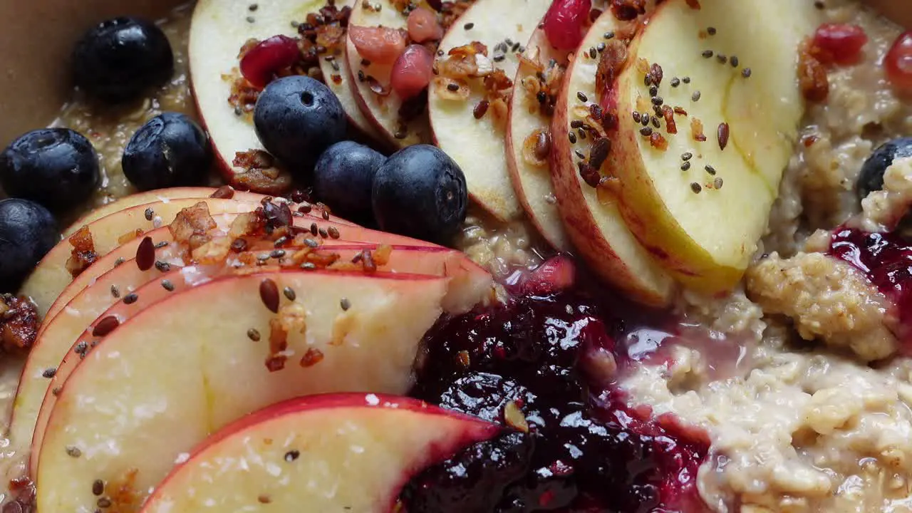 Hot porridge with apples and berries close up