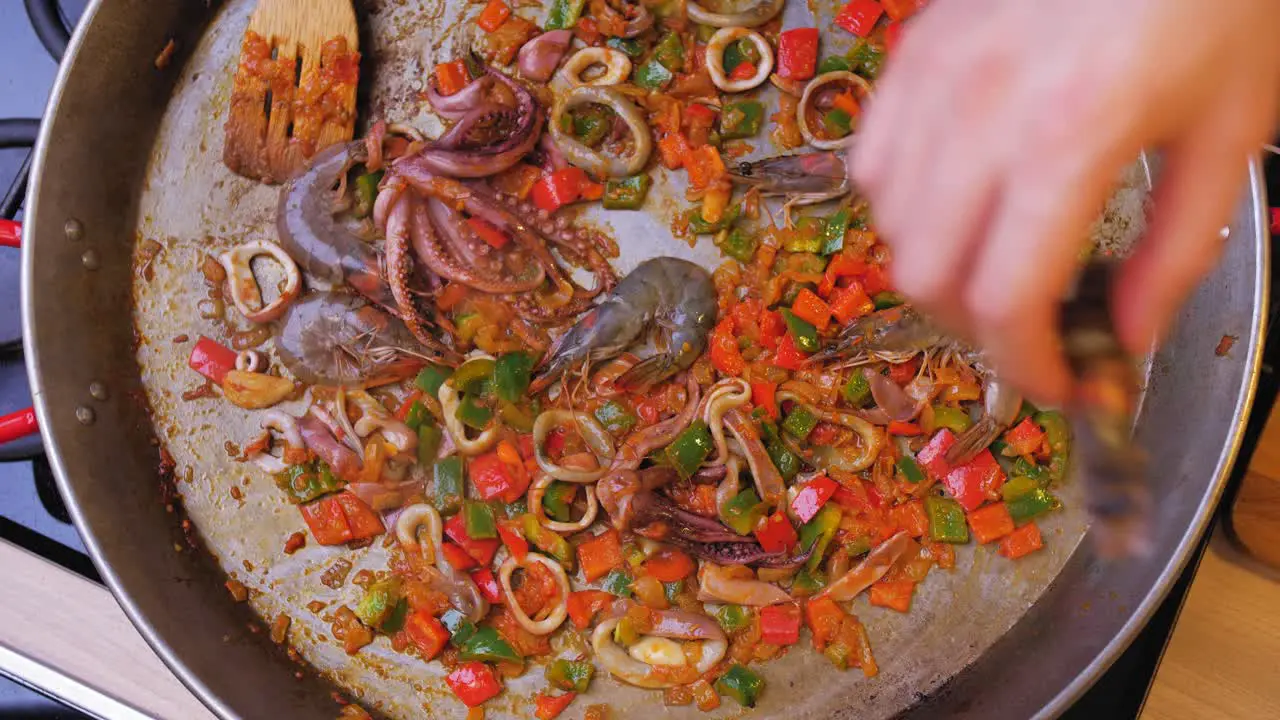 the cook throws the shrimp into the pan top down