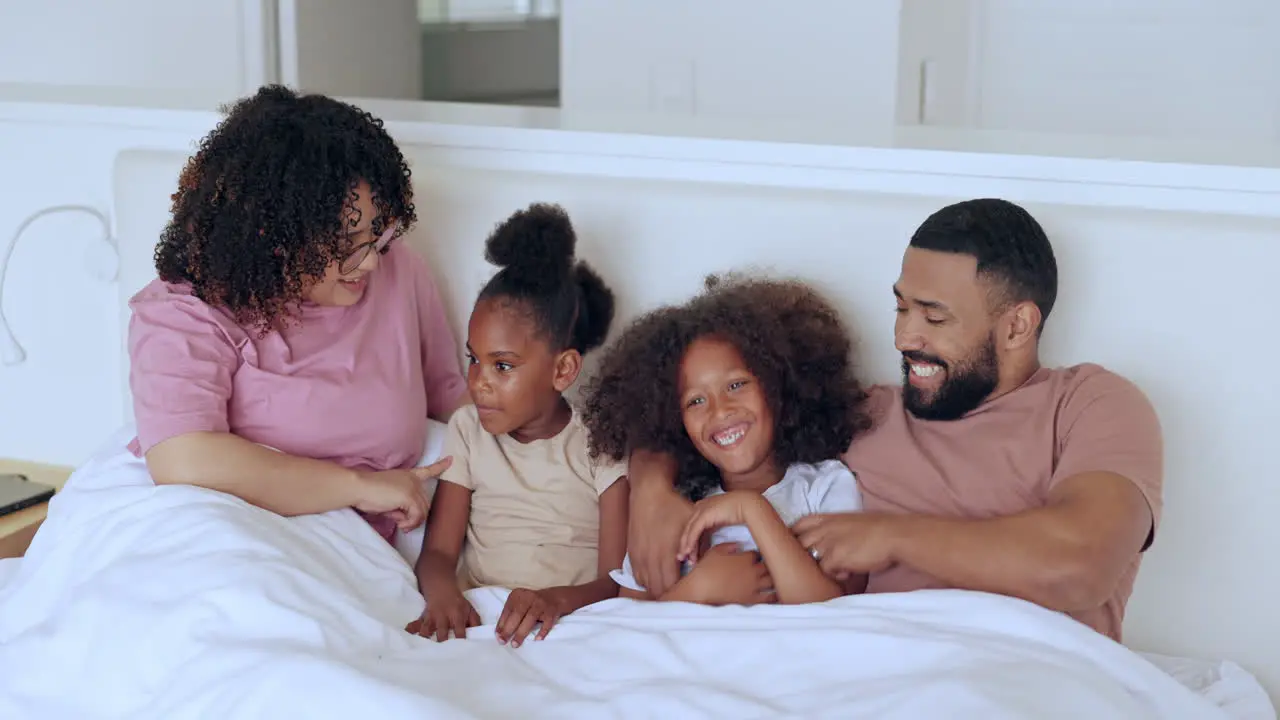 Parents children and playing in bed