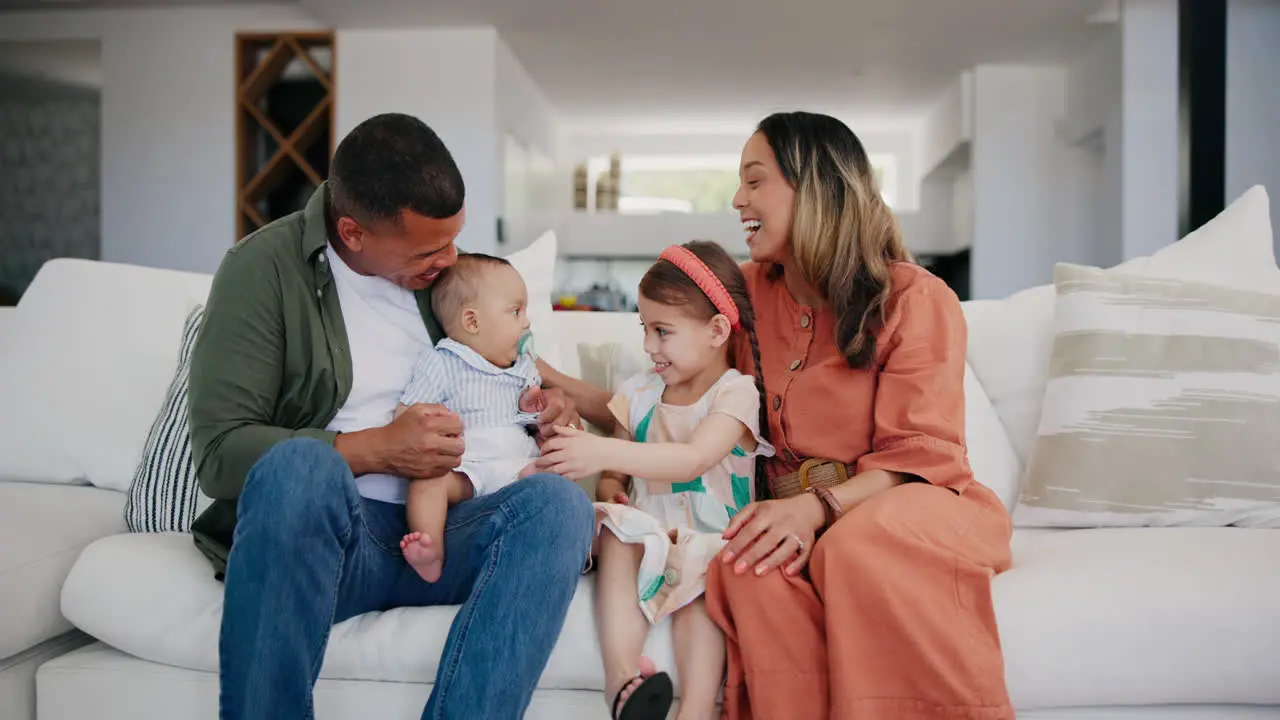 Happy family baby and parents on sofa in home