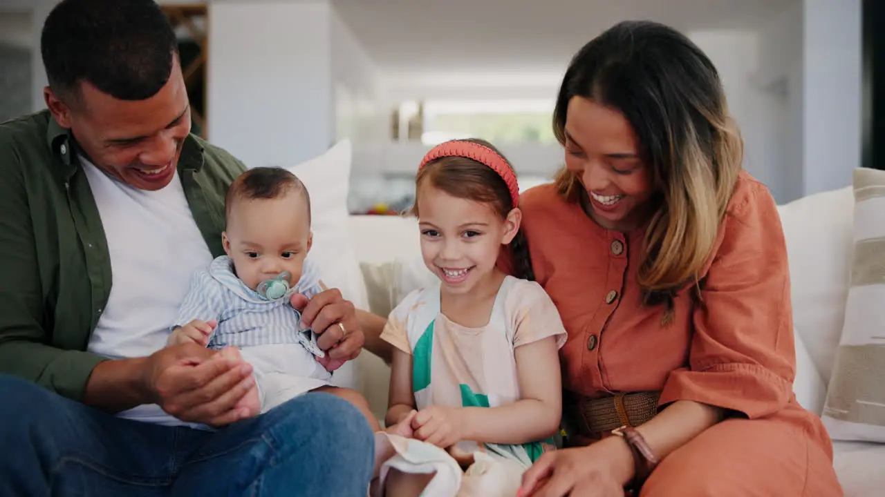 Happy family baby and parents with kid on sofa