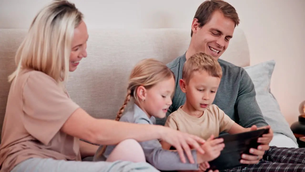 Parents kids and tablet in bedroom for games