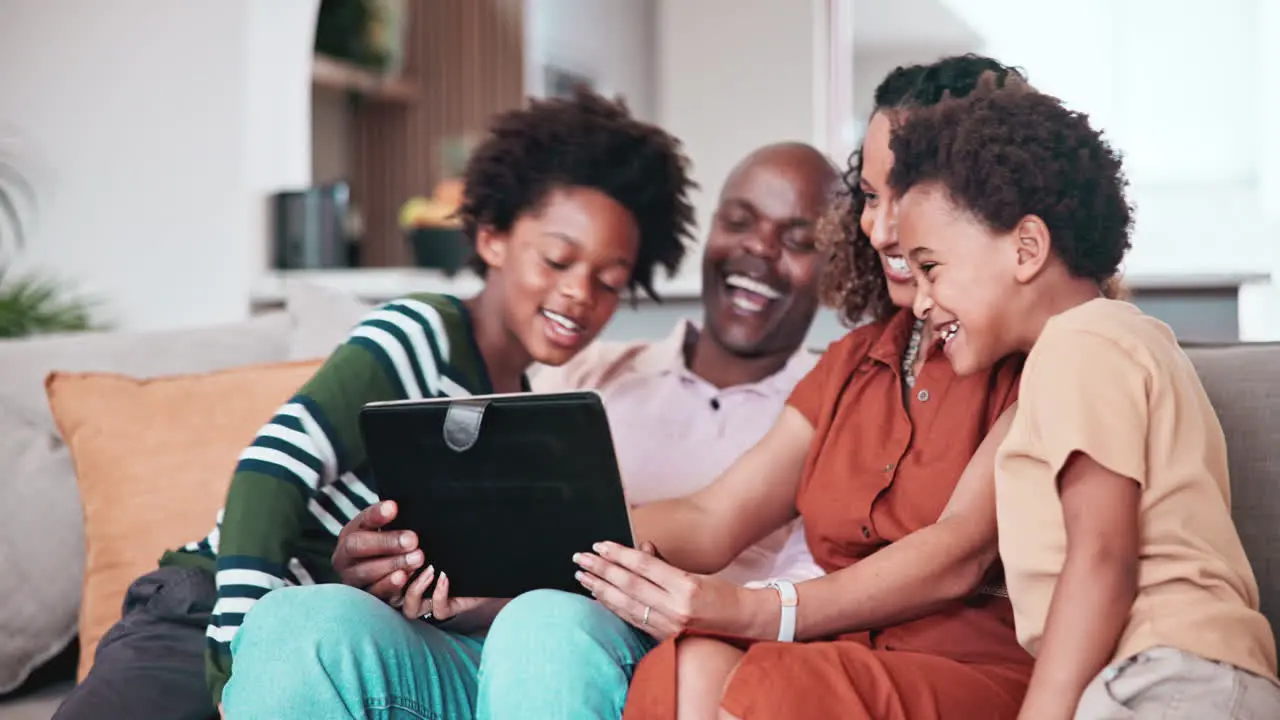 Home tablet talking and happy African family