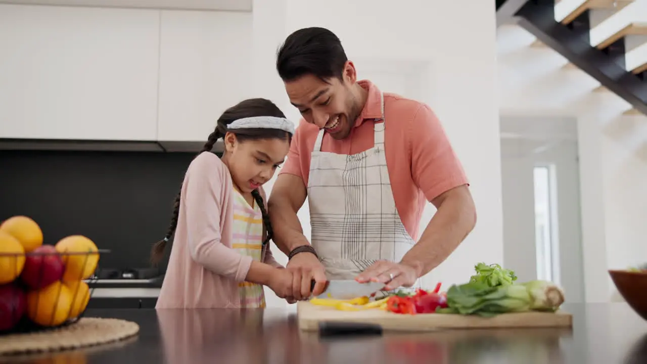 Father girl child and cooking with knife