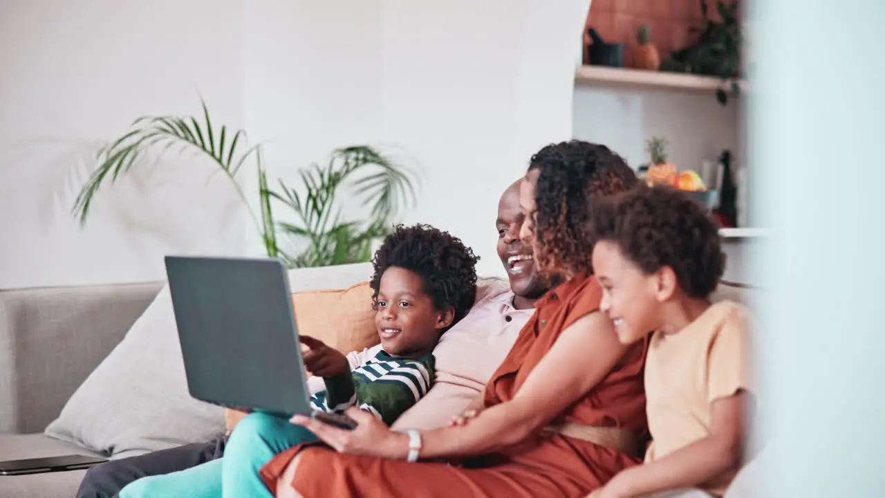 Home laptop talking and happy African family