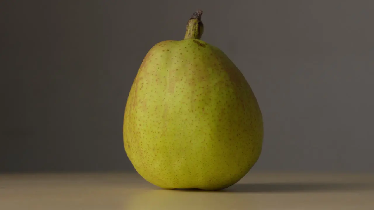 Light Shining And Dimming On Whole Fresh Pear