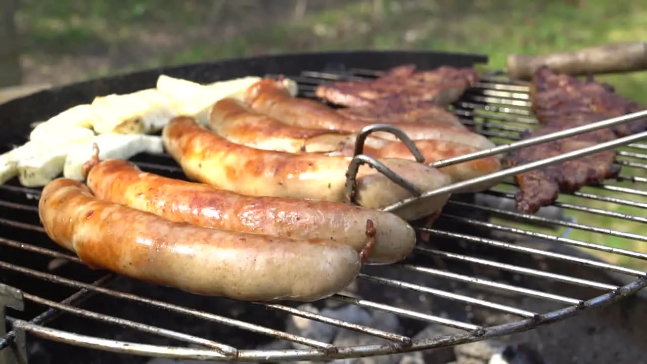 German Bratwurst a Traditional Sausage on Grill in Slow Motion