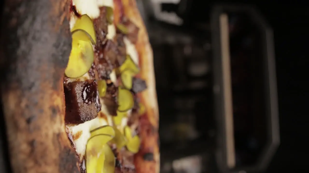 Close up Portrait Shot of Rotation of Delicious Italian Freshly Cooked Pizza in Front of the Oven