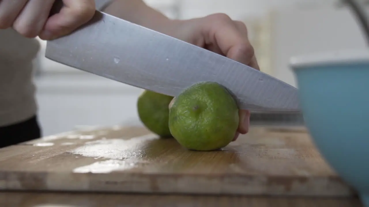 Cutting a lime in half in the kitchen