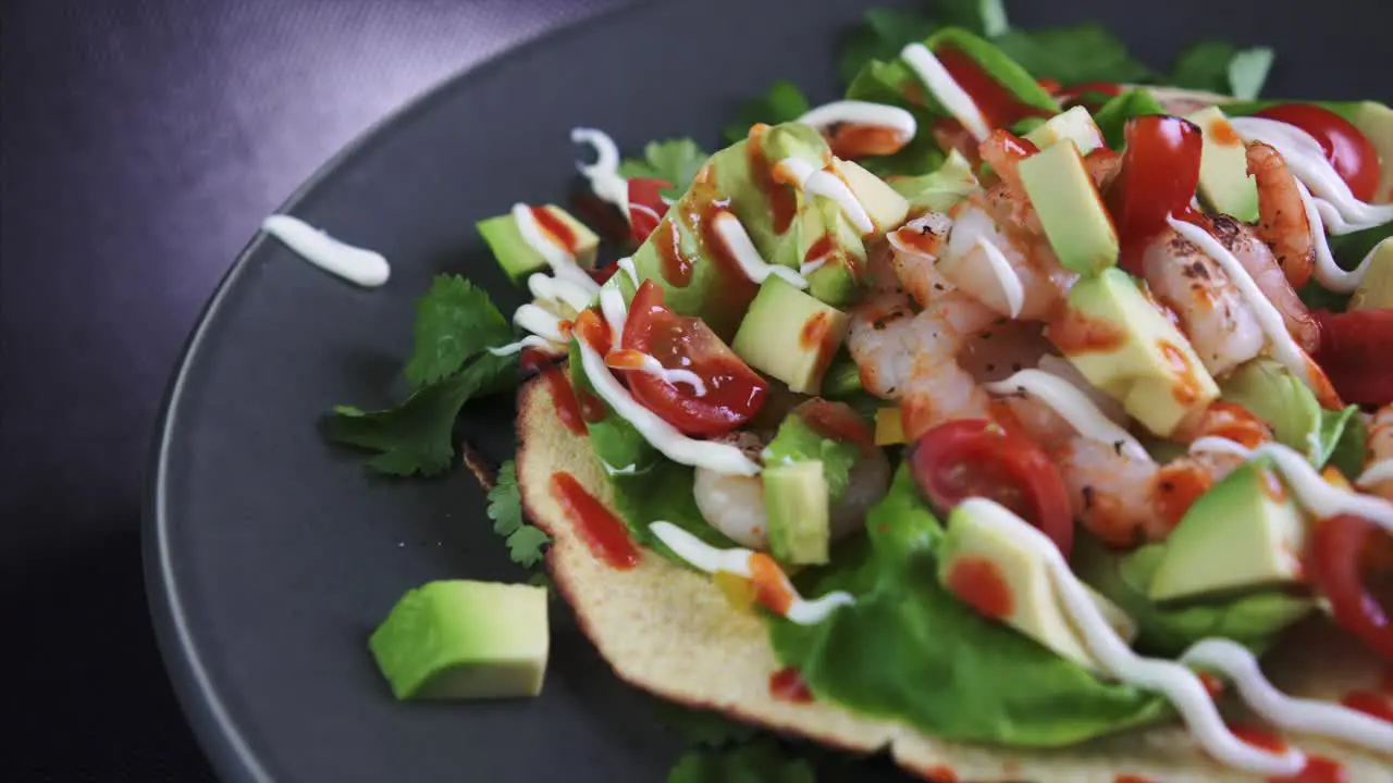 Extreme Close Up of a Freshly Prepared Flat Open Shrimp Taco rotating on black background 4k