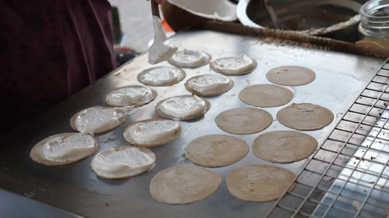 Thai street food vendor making a famous Thai Crispy Pancake