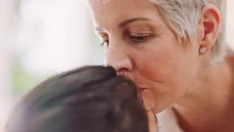 Family love and grandmother kiss girl on forehead