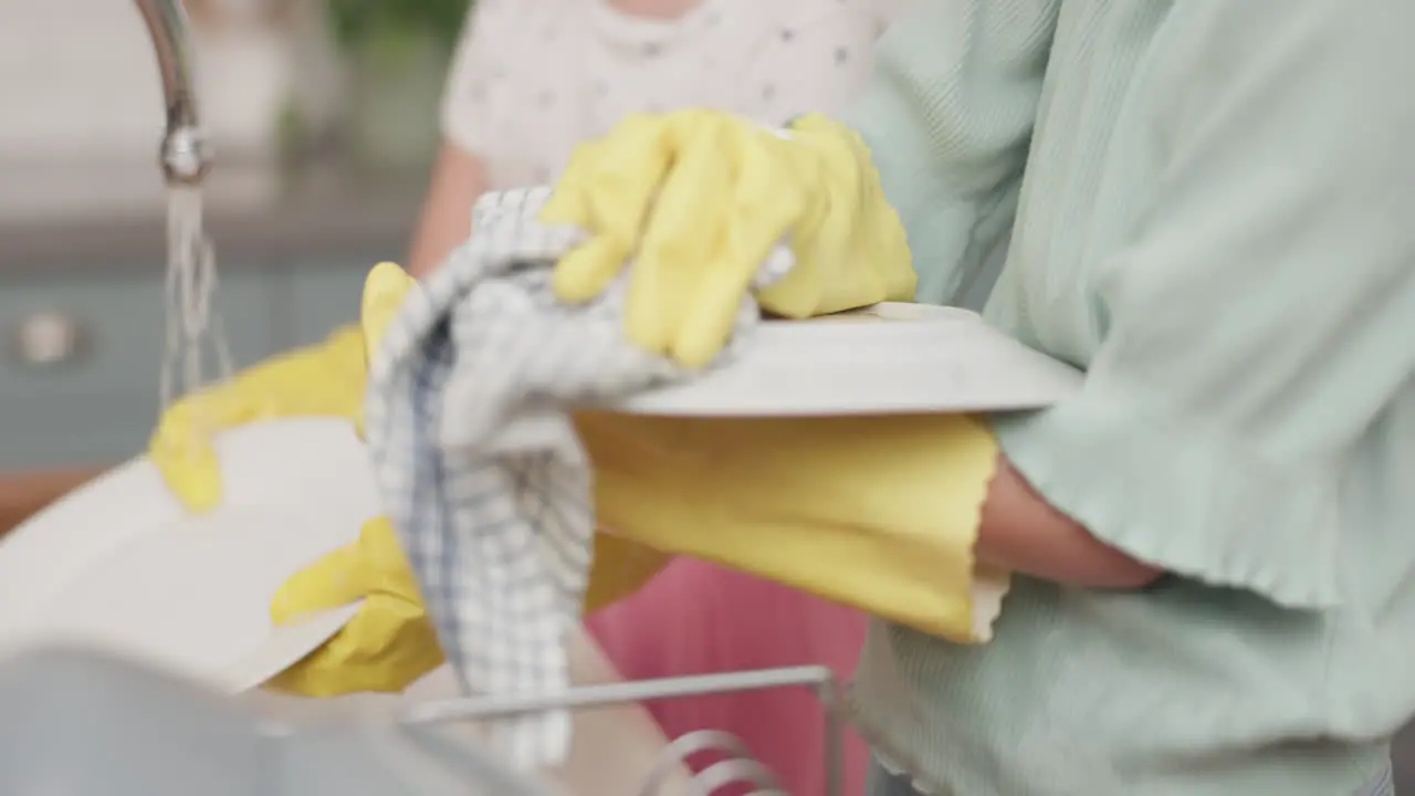 Kitchen mother and clean with girl in closeup