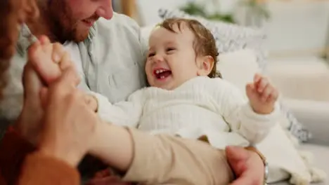 Love happy family and baby playing on a sofa