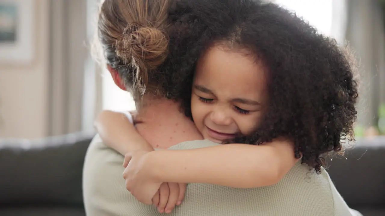 Love face and girl child hugging mother on a sofa