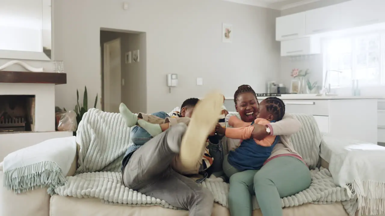 Mother father and children on sofa playing