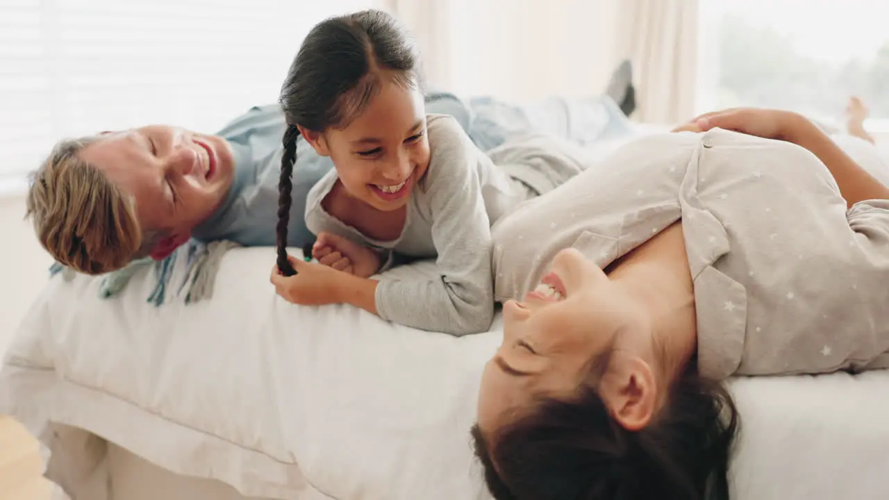 Happy family bed and child laughing in a bedroom