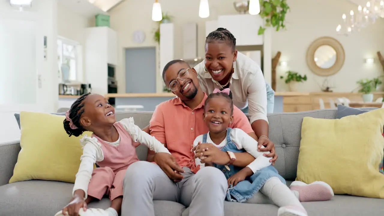 Happy black family on sofa