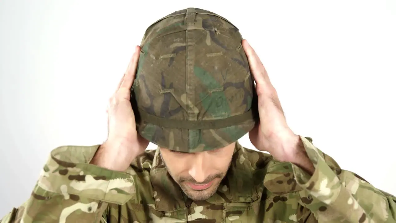 Soldier wearing combat helmet on white background