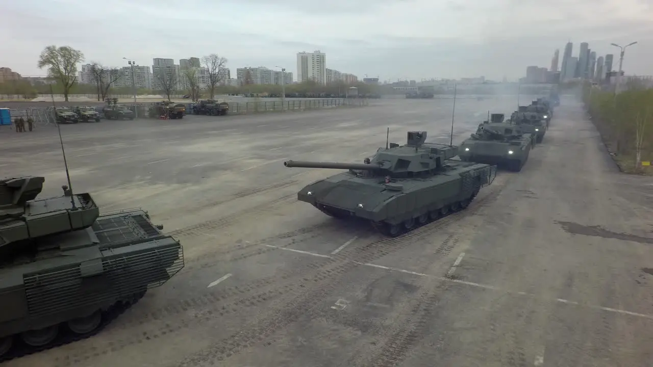 Aerial shot of tanks in columns setting off from military base Russia