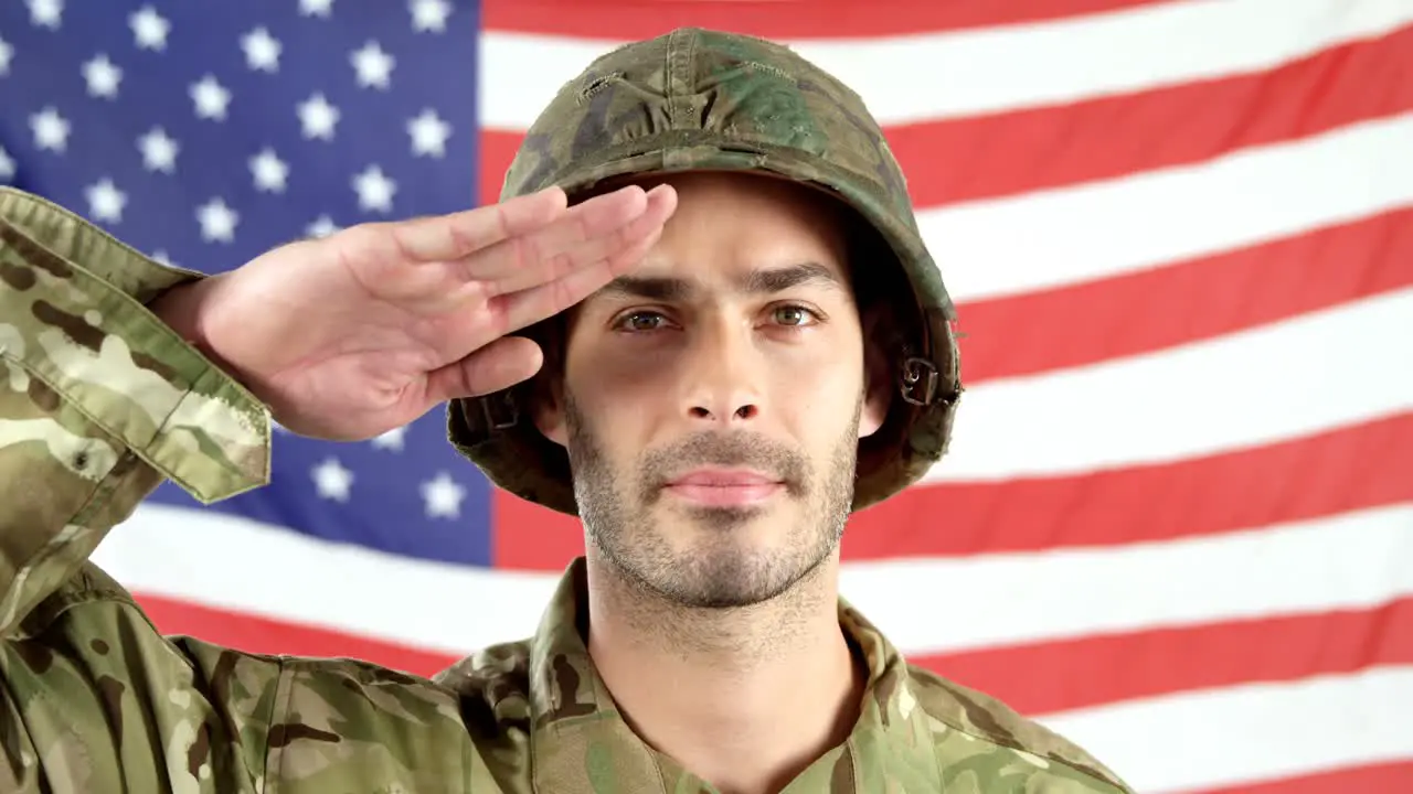 Soldier saluting in front of American flag