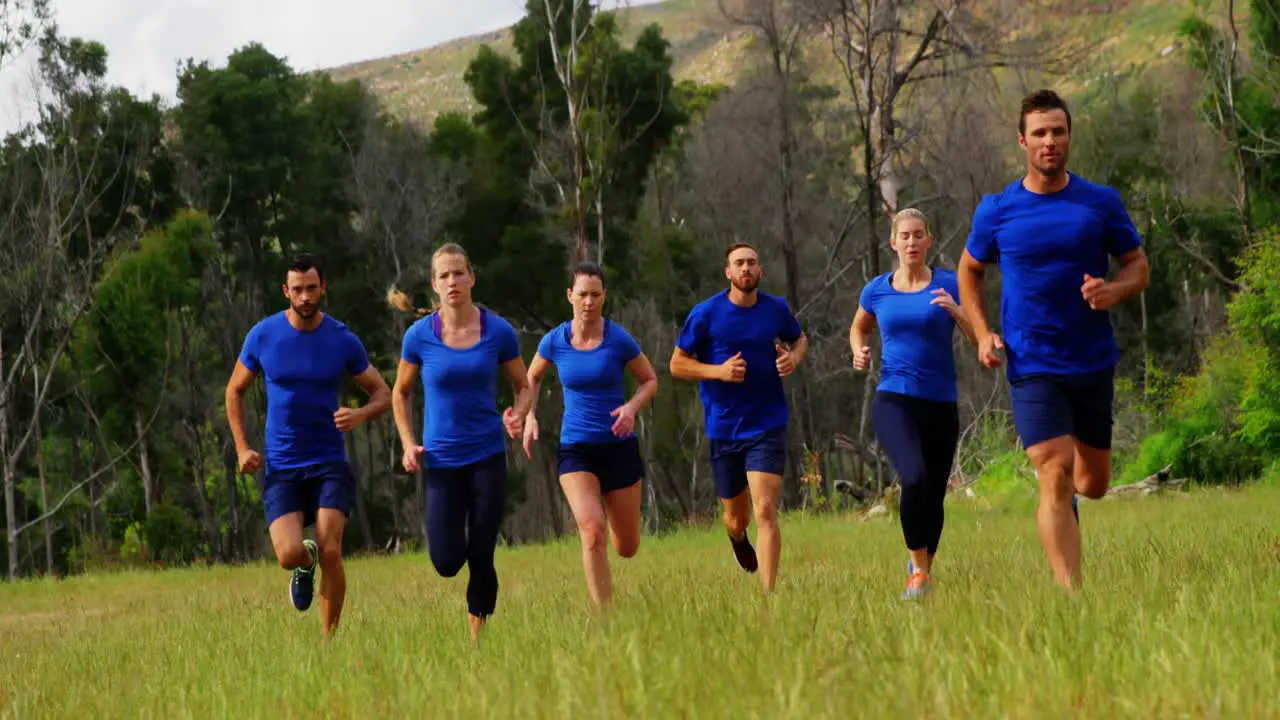 Fit people jogging in boot camp 4k