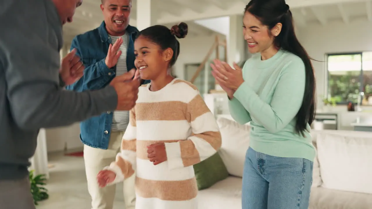 Dancing family home and clapping for child to