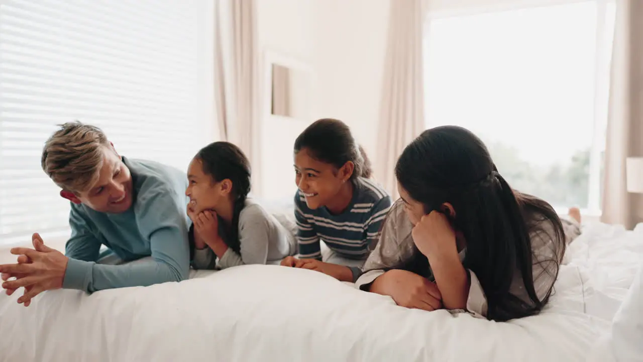 Happy family bed and kids playing in a bedroom