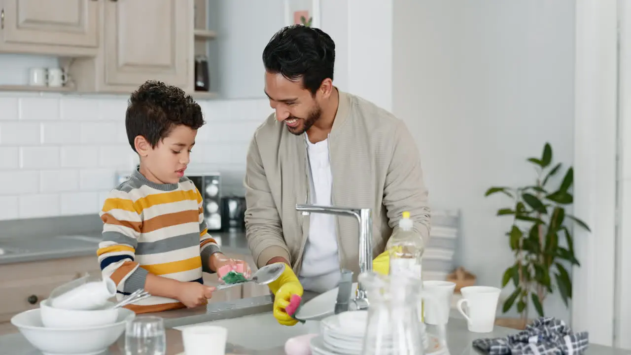 Teamwork father or kid washing dishes