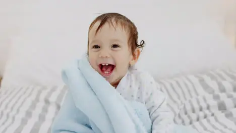 Laughing baby kids and peekaboo with blanket