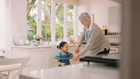 Dancing child and grandmother in family home