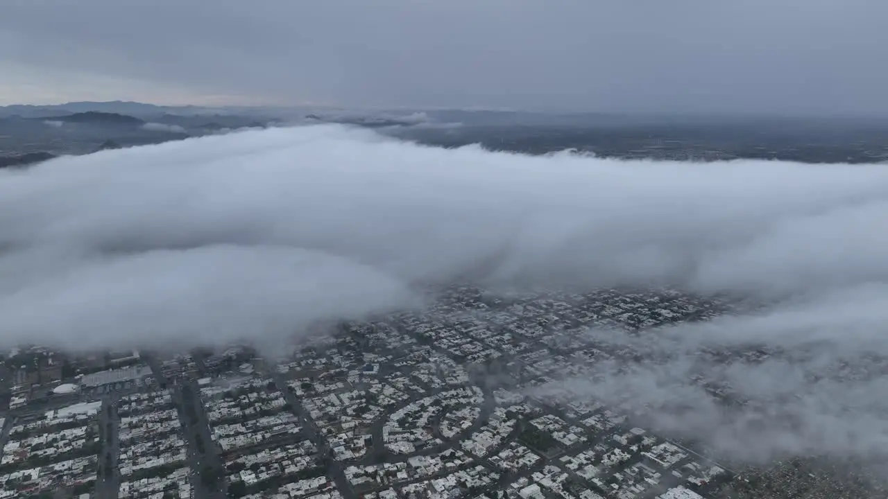 aerial shot of drone flying above the clouds on a cloudy day