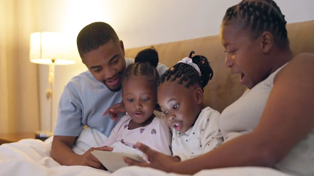 Happy bed and black family with a tablet