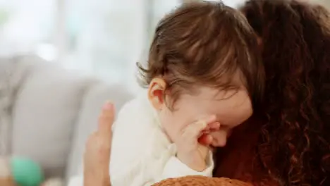 Tired baby and mother yawning on sofa before