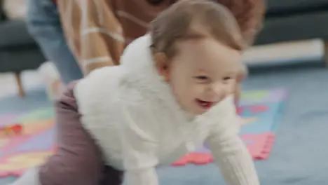 Happy baby and mother playing while crawling