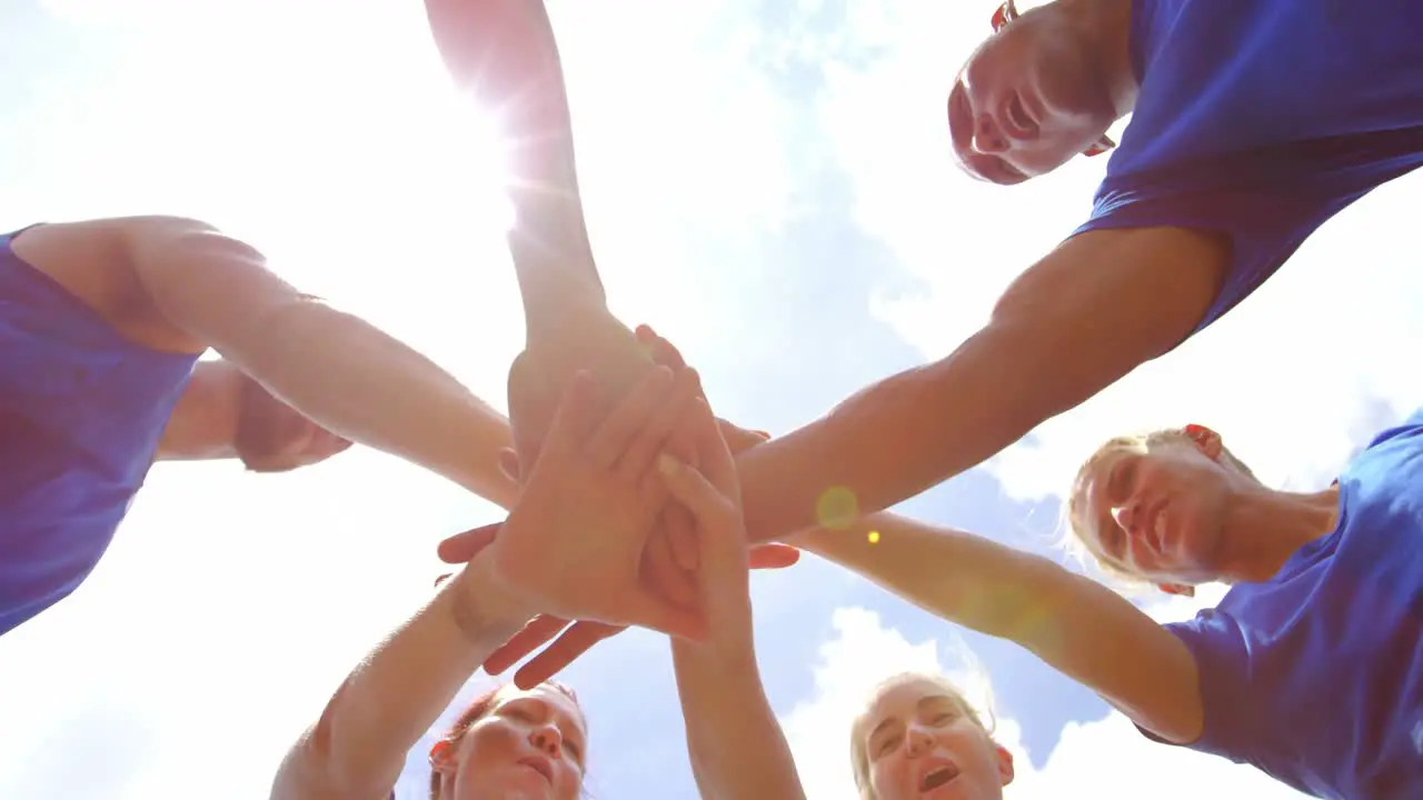 Fit people forming hands stack in boot camp 4k