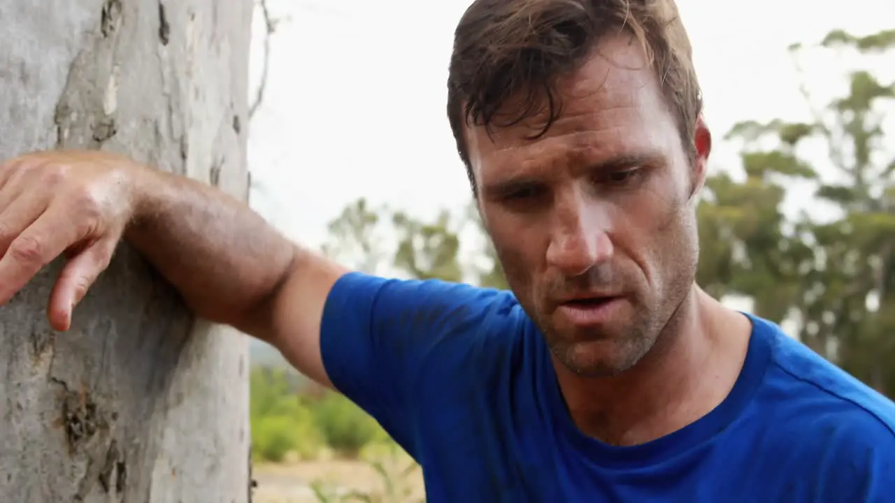 Fit man relaxing after workout during obstacle course