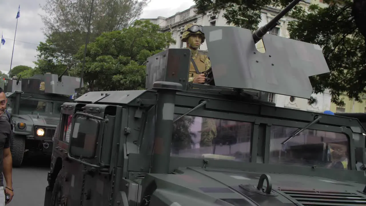 Soldier operates a turret on a military armored vehicle as it parades along the streets of the city of San Salvador during the country's independence day celebration