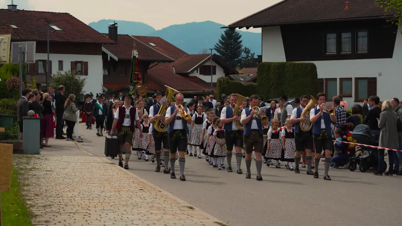 Music brass group band in traditional Bavarian clothes Lederhose and Dirndl at Maibaumaufstellen