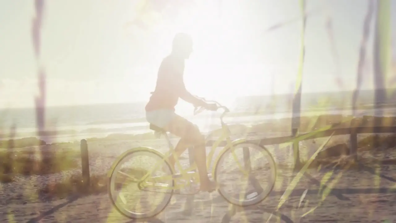 Animation of grass over caucasian woman on bike on beach