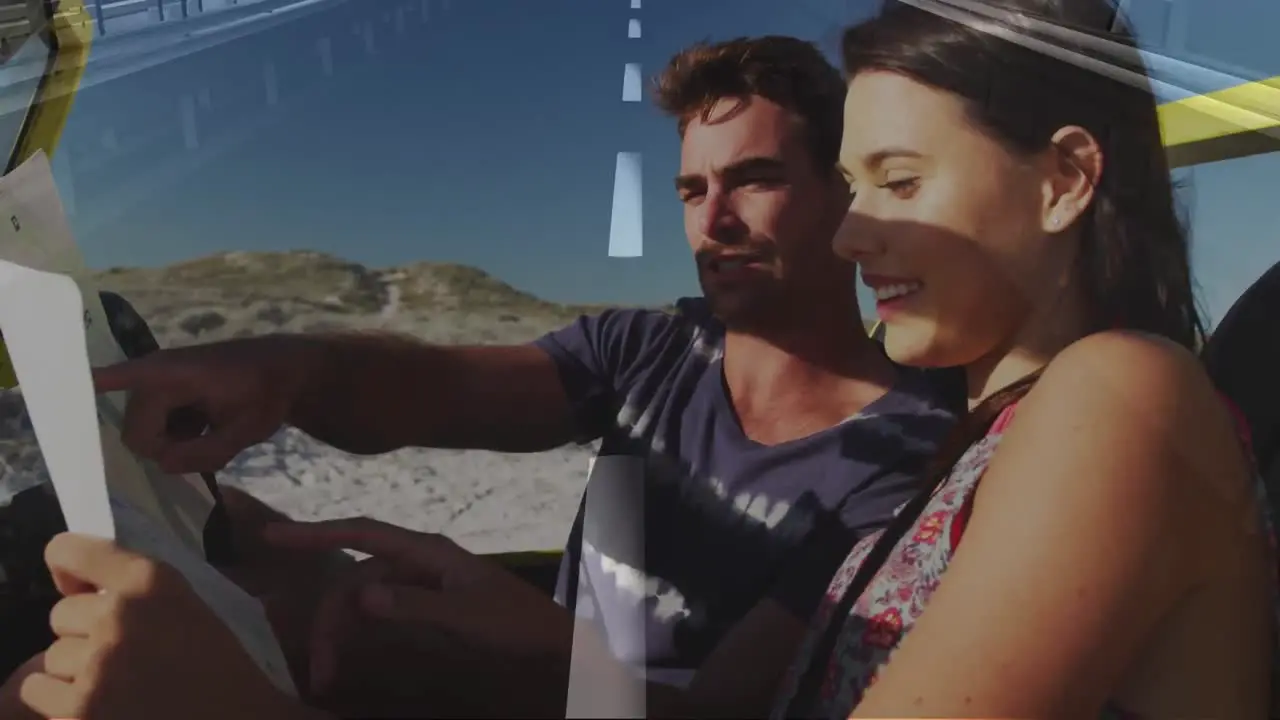 Animation of moving road over happy caucasian couple with map in car on beach