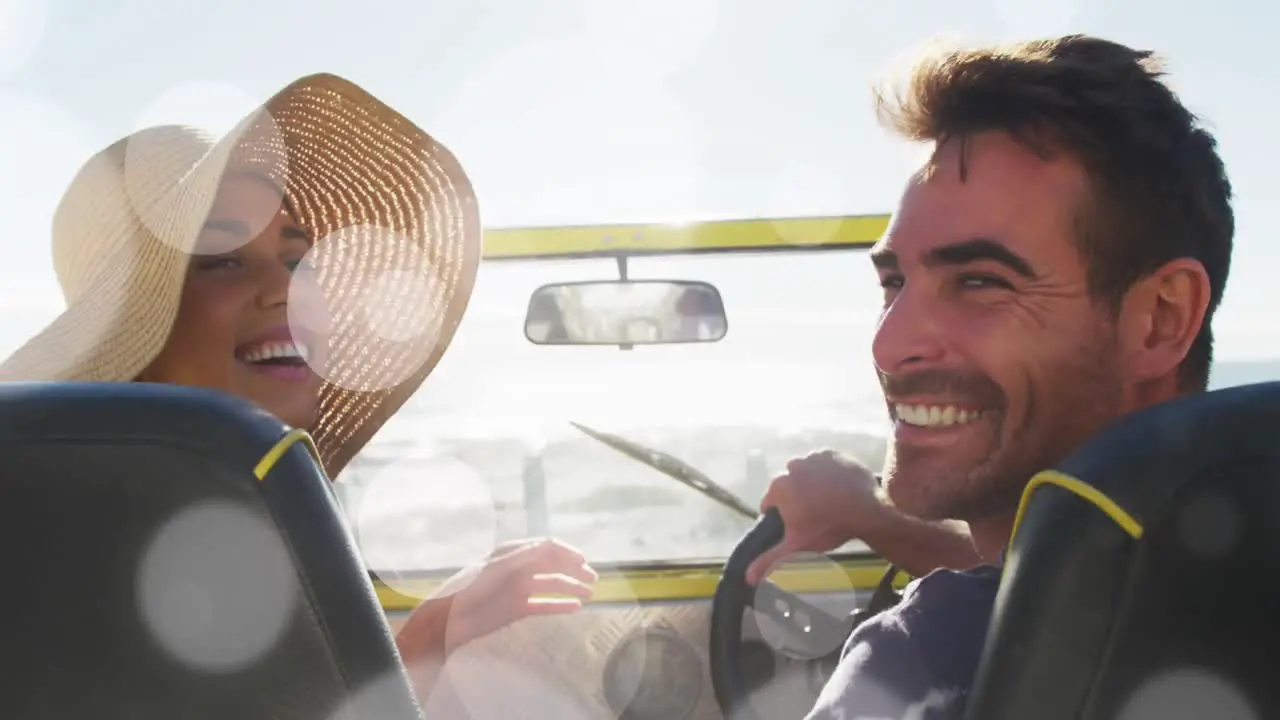 Animation of dots over happy caucasian couple in car on beach