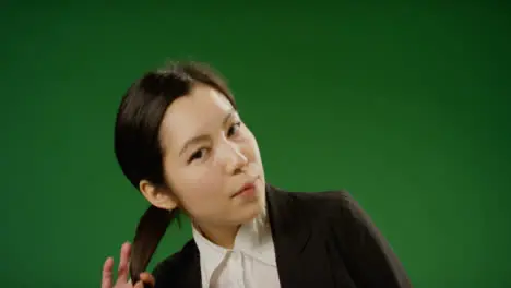 Portrait of Businesswoman moving her hair on green screen