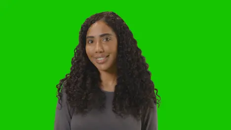 Portrait Of Woman Against Green Screen Smiling At Camera 1