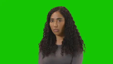 Portrait Of Sad Looking Woman Against Green Screen