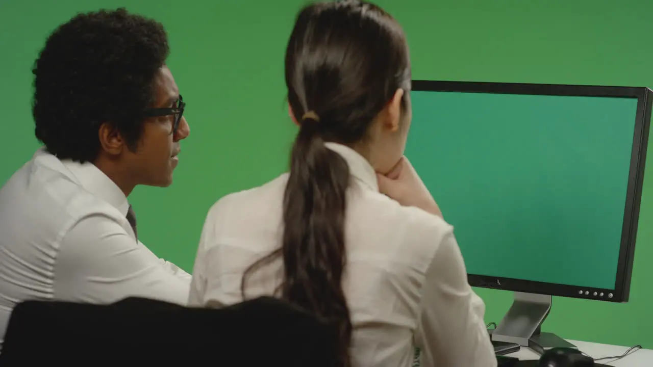 Colleagues Look Concerned at Computer on Green Screen