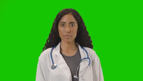 Portrait Of Female Doctor In White Lab Coat With Stethoscope Against Green Screen