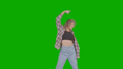 Studio Shot Of Young Woman Having Fun Dancing Against Green Screen 24